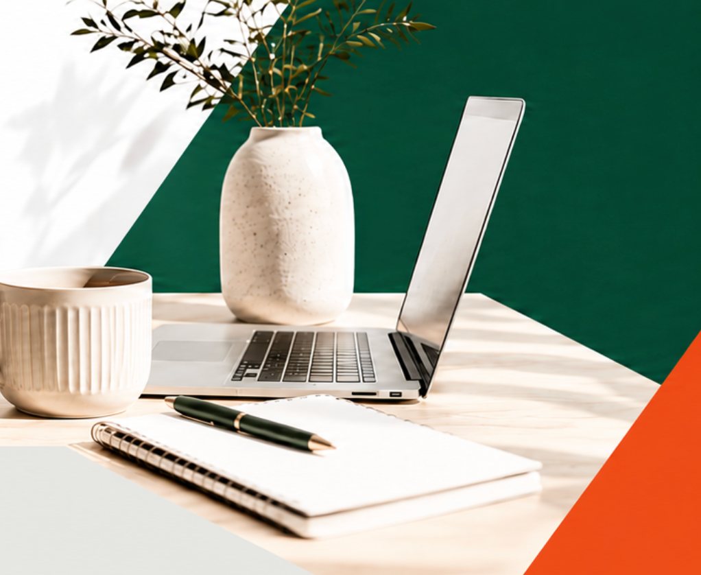 A calm desk with notebook, laptop, coffee and olive branches
